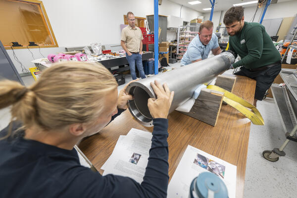 A group assembling a seismometer at the Physical Sciences Laboratory.