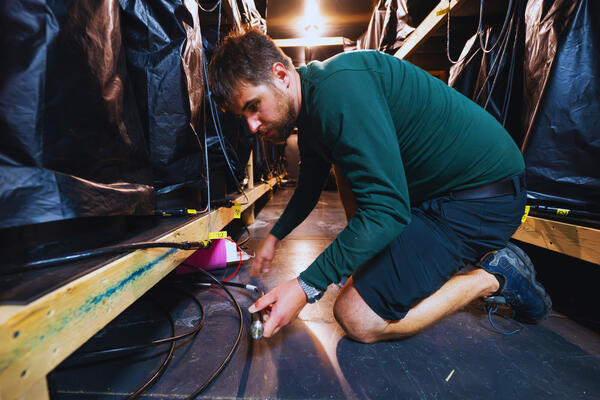 USGS Rob Anthony sets up equipment in a freezer to test a Seismometer.