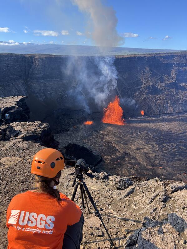 Color photograph of scientist monitoring eruption