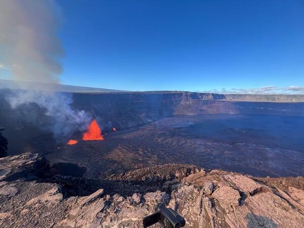Color photograph of erupting lava fountains within a crater