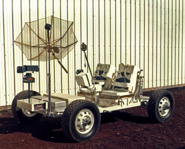 A photo of Grover the Geologic Rover against an aluminum corrugated wall