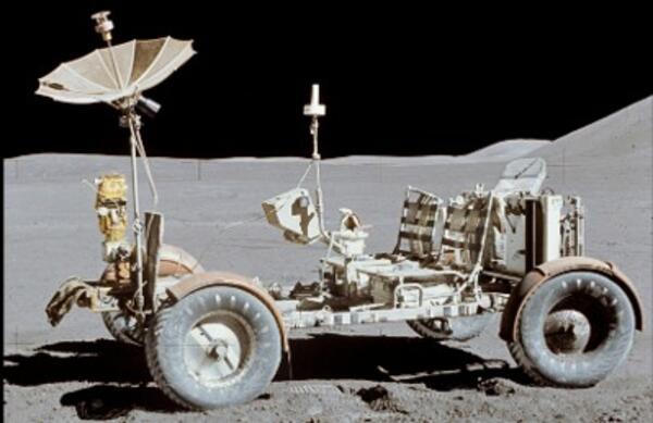 The lunar roving vehicle on the Moon: a bare-bones open cart-type vehicle with several instruments resting on the gray Moon