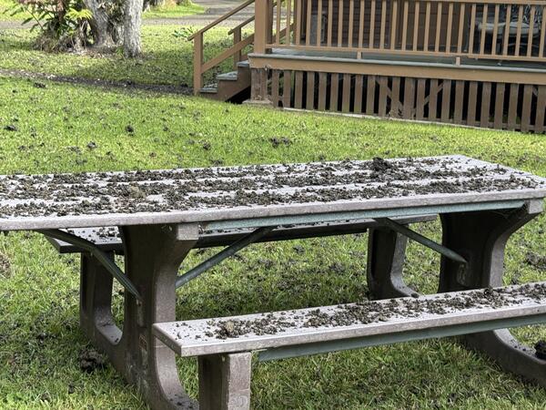 Color photograph of tephra covering a picnic table