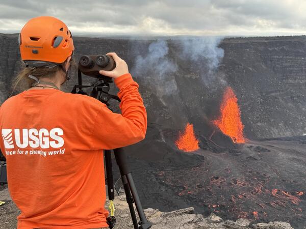 Color photograph of scientist monitoring eruption 