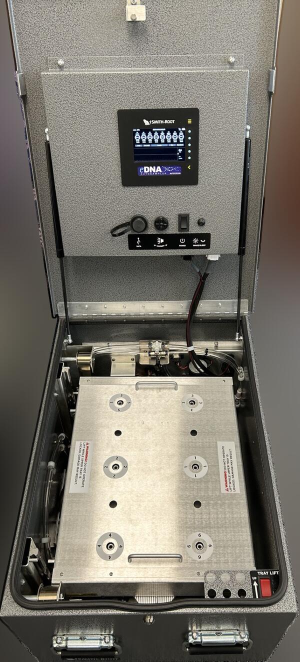 An open eDNA autosampler device "box" showing the control console and inside mechanisms