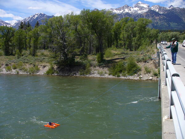 Hydrologist measuring at USGS Streamgage 13013650 near Moose, Wyoming from the bridge