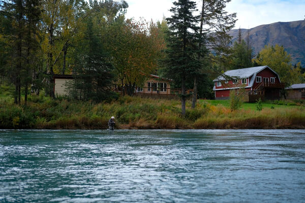 Homes and a fisher along the Kenai River.