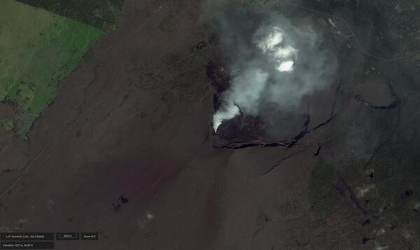 Satellite image of the summit of a volcano showing a caldera and volcanic gas plume