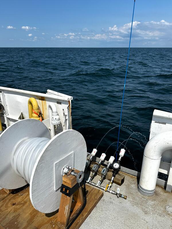 Large volume surface water sampling equipment on side of research boat on large lake