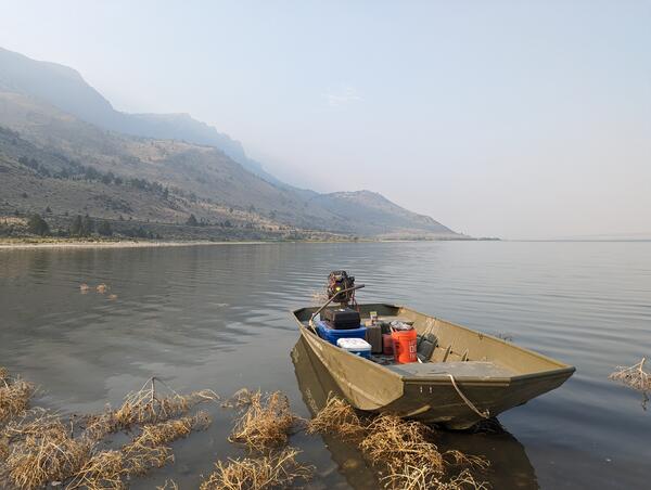 Boat near the shore of Lake Abert on a smoky day