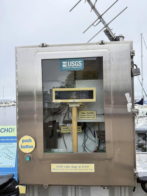 A USGS streamgage in a metal box with a clear door.