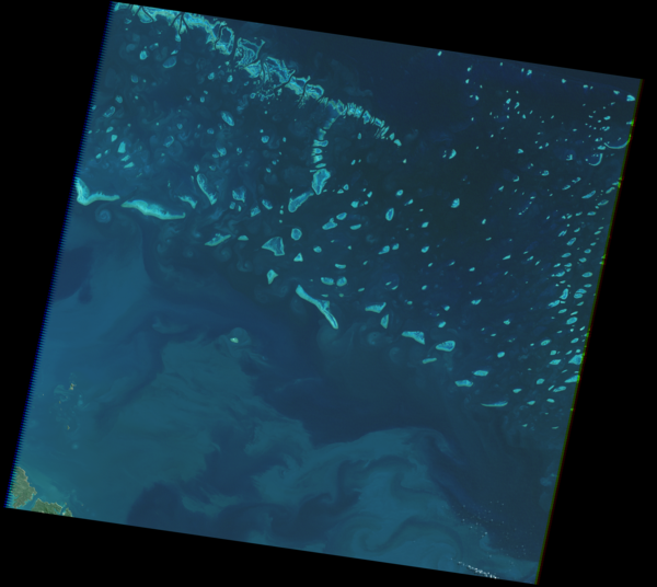 Aerial view of of blue water with bright blue reefs