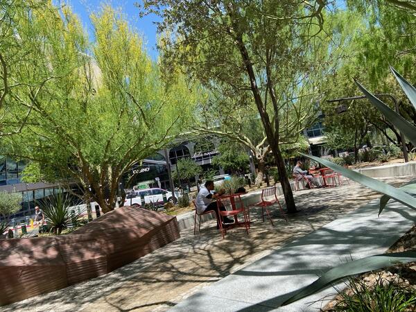 Park off Las Vegas strip surrounded by green trees and blue sky