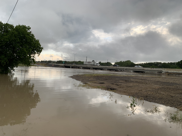 Floodwaters are shown rising high under the I-35 highway overpass over Leon Creek, Texas. 