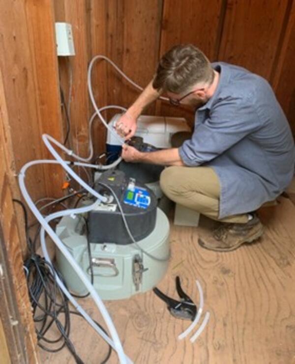 Scientist setting up equipment for storm water sampling