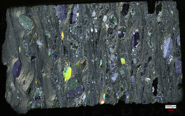 Microscopic image of schist showing garnets