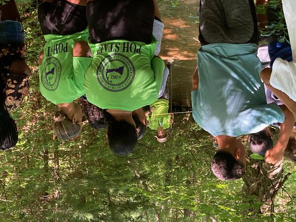 group of people in wooded area