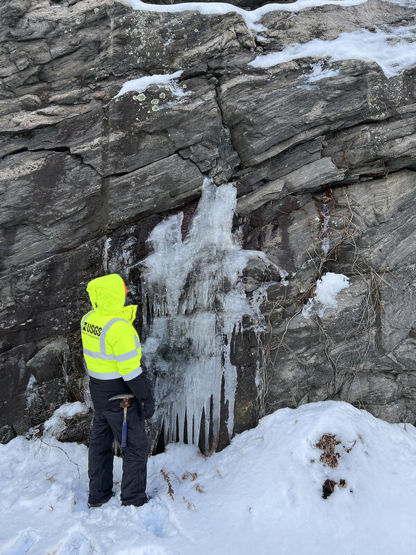Geologist examines water bearing fractures.