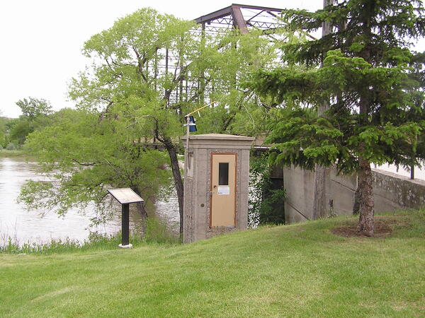 A streamgage on the banks of the brown Missouri River in Fort Benton, Montana. 
