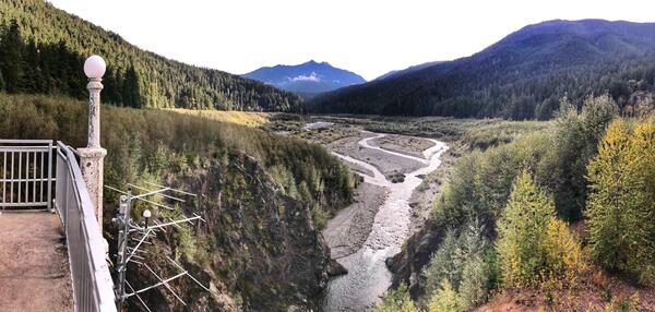 antennas mounted on a concrete balcony high above a gravelly braided river running through steep forested hills