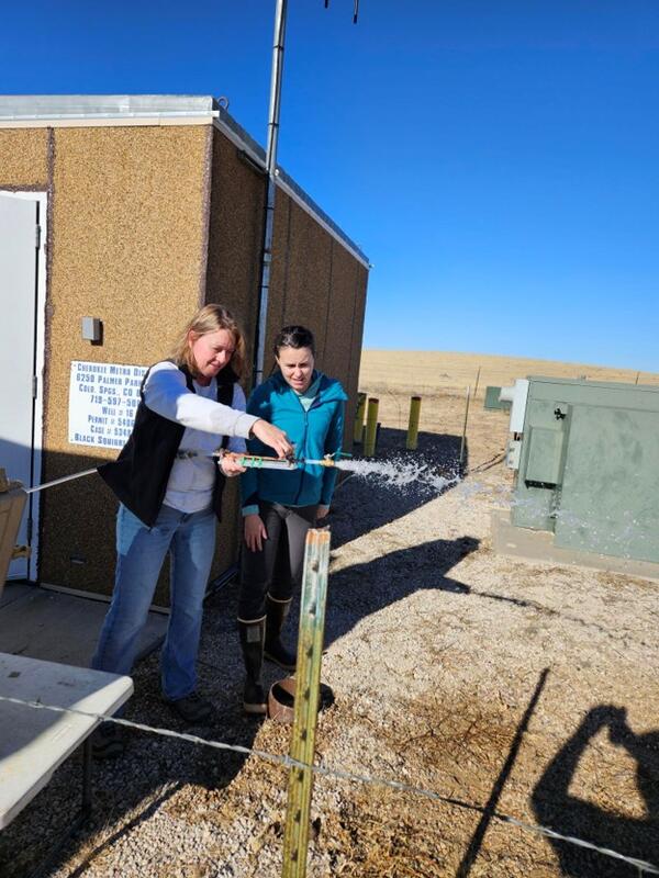 Photo of USGS employees creating back pressure at a production well