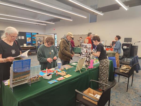 Image of USGS and EPA scientists behind tables, engaging with the public about the science we do