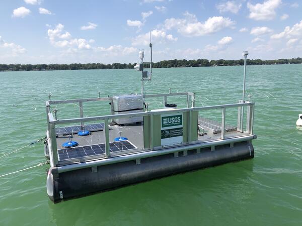 A rectangular platform floats on green tinted waters