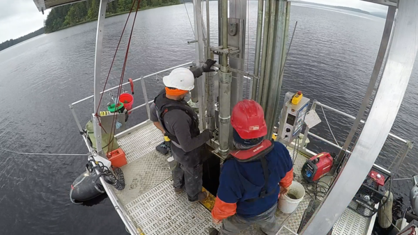 Photo of scientists at Ozette Lake operating the Uwitech coring platform