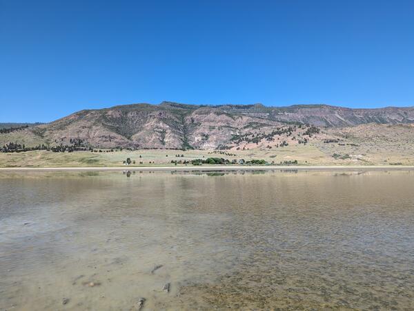 shallow 2 to 5 inches deep water with mud and silt visible below the surface. 