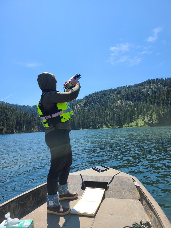 USGS scientist using spectral radiometer to measure light from boat on Fernan Lake, Idaho