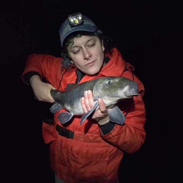 Scientist holding a Lost River Sucker fish