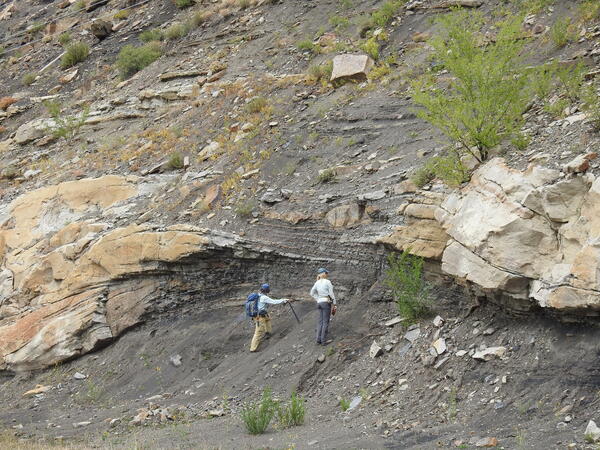 Geologists examining Paleocene fluvial deposits in the Raton Basin, Colorado 