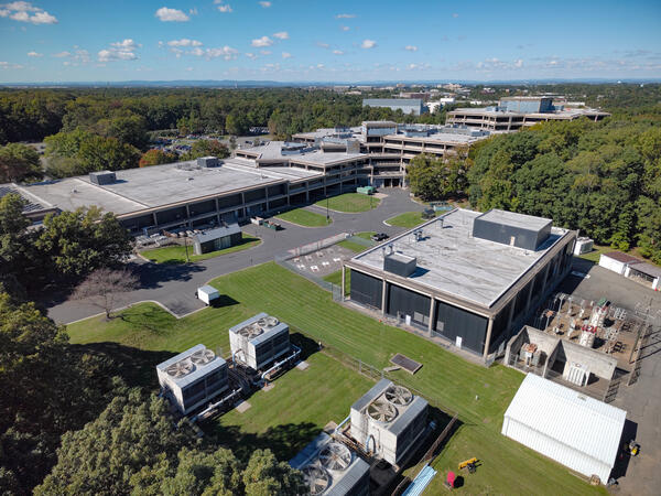 building and parking lot surrounded by trees
