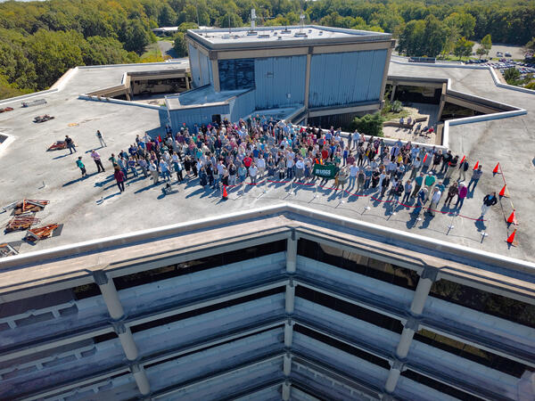 building and parking lot surrounded by trees