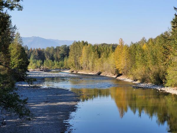 River with fall foliage and mountains in background