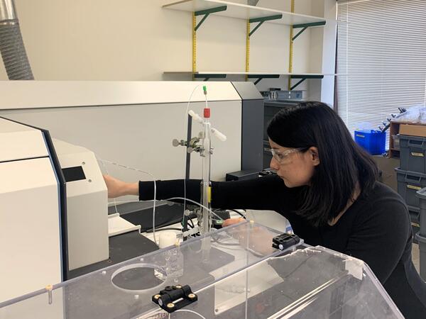 Scientist preparing laboratory machine for analysis