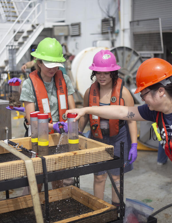 Scientists preparing push core samples during the Hawaii Abyssal Nodules Expedition