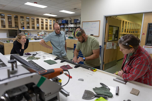 Scientists separating a sediment core split lengthwise