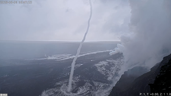 Color photograph of a whirlwind near a steamy volcanic vent in a crater