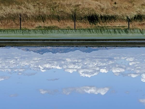 Viewed from a distance, a small mountain range sits isolated among broad, flat fields.