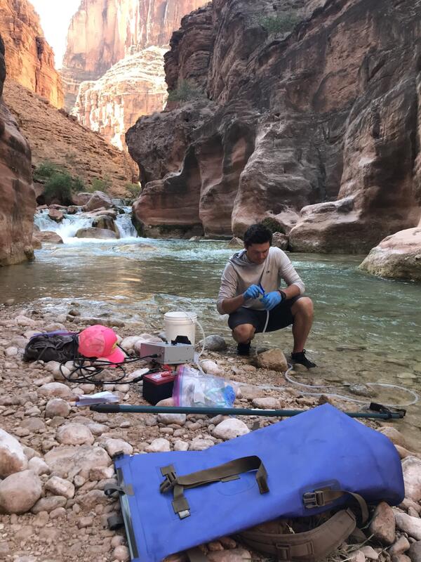 A scientist with the US Forest Service works with eDNA sampling equipment at Havasu Creek near the mouth of the Colorado Rive