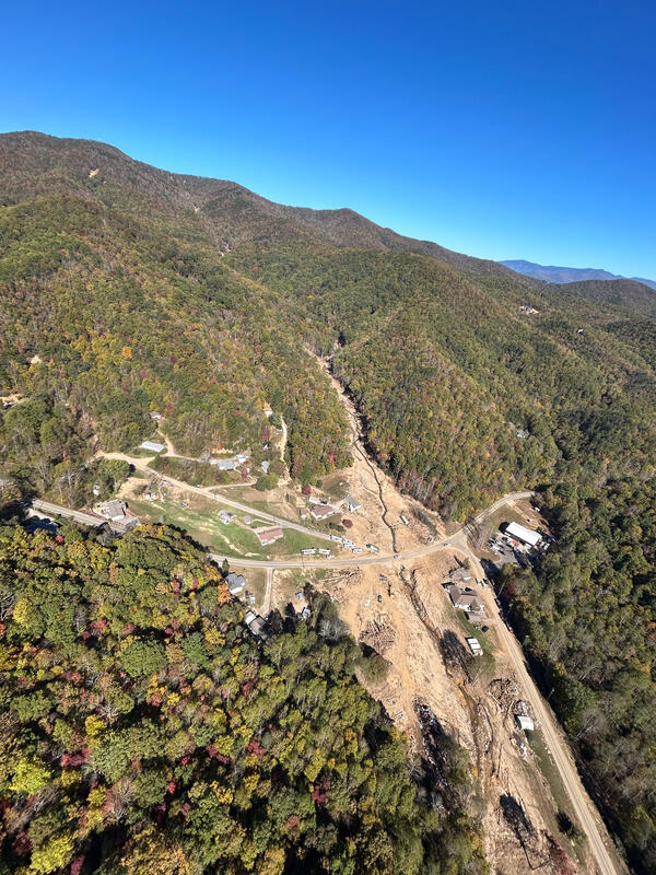aerial view of stream flowing through a landslide runout path