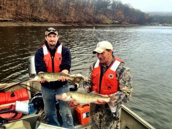 Two researchers are holding walleye in West Virginia