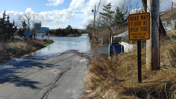 Flooded portion of a street near the Wading River after a winter storm.