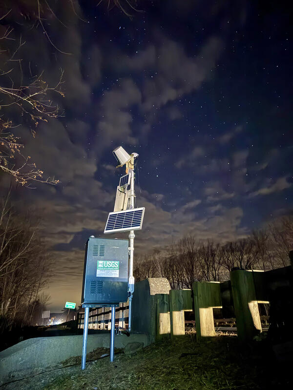 Photo of a U.S. Geological streamgage with solar panels added to help charge battery due to low light in the winter.