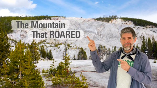 Main pointing to a barren mountainside with steam vents