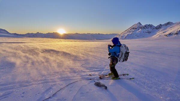 Person on skis standing on a glacier.