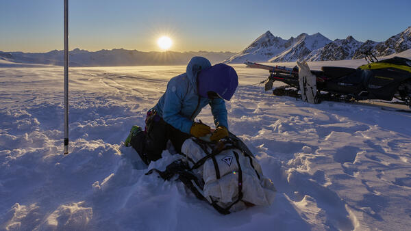 Person taking notes while on a glacier.