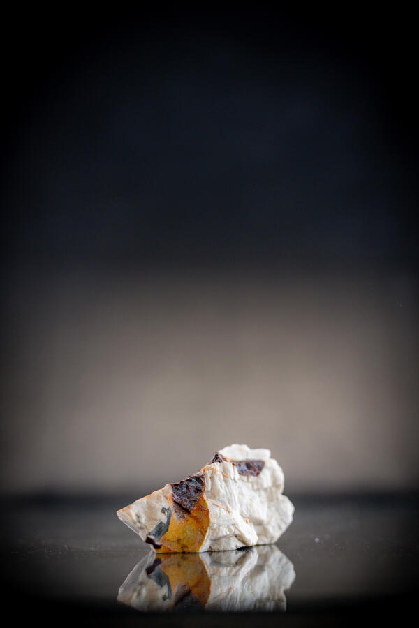 Isolated USGS mineral specimen featuring almandite garnet and calcite.