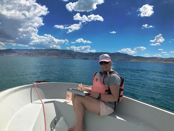 Phaedra Budy sitting on a boat on a Utah lake